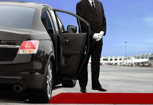 San Antonio limousine chauffeur with door opened at airport